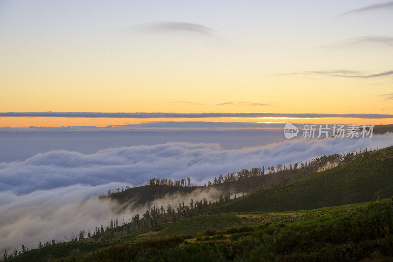 Clouds over the mountains near Rabaçal on Madeira island during sunset